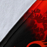 Close-up of black-and-red wave and floral blanket print texture