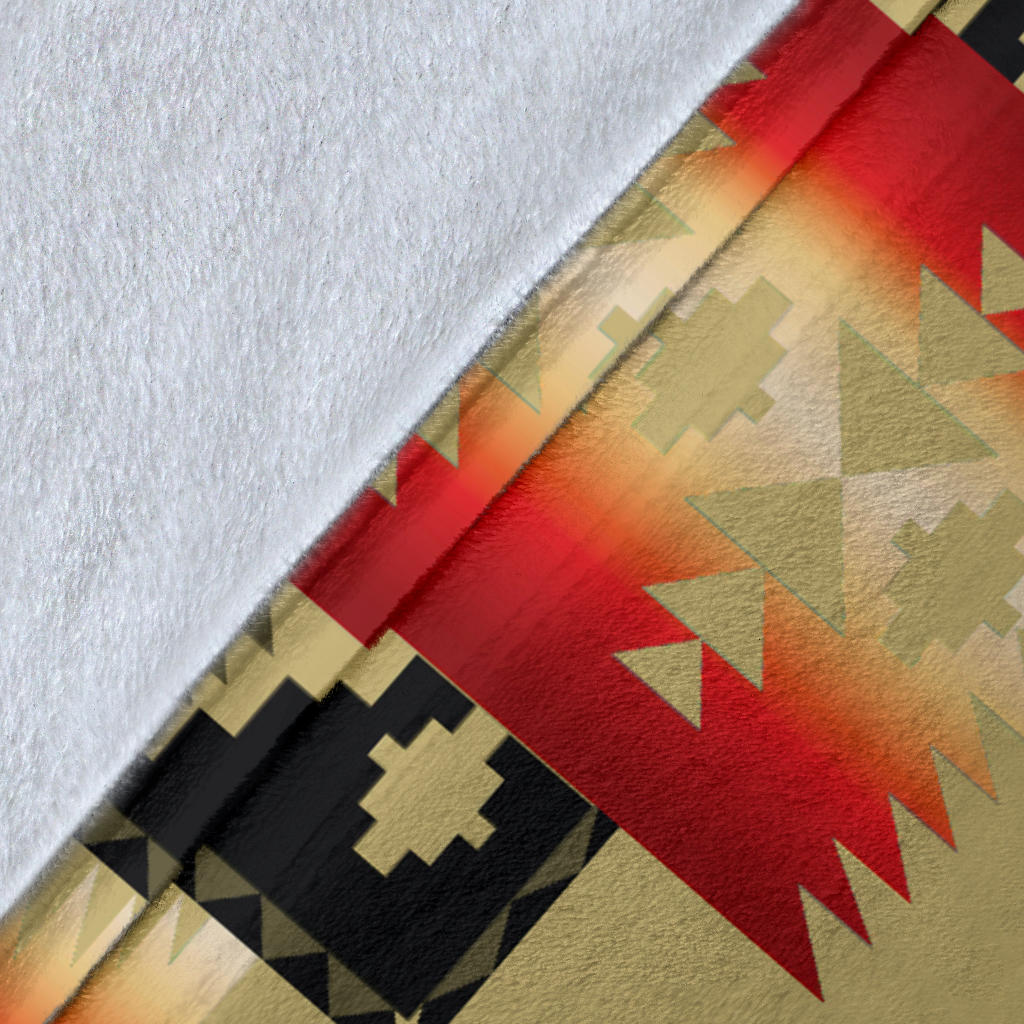Light brown blanket fabric corner with red gradient stripe and black cross motif