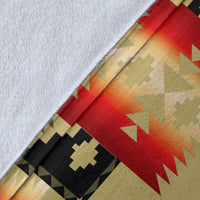 Light brown blanket fabric corner with red gradient stripe and black cross motif