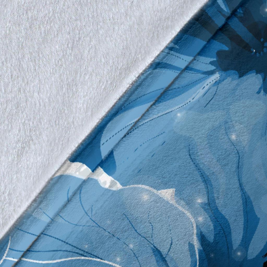 Close-up of blue turtle and hibiscus print on soft blanket fabric, textured weave