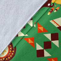 Close-up of green blanket fabric with multicolor geometric shapes and tent pattern