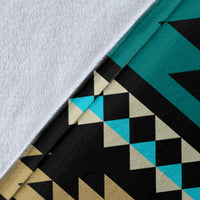 Close-up of teal Aztec blanket print with black, tan, and light-blue checker shapes