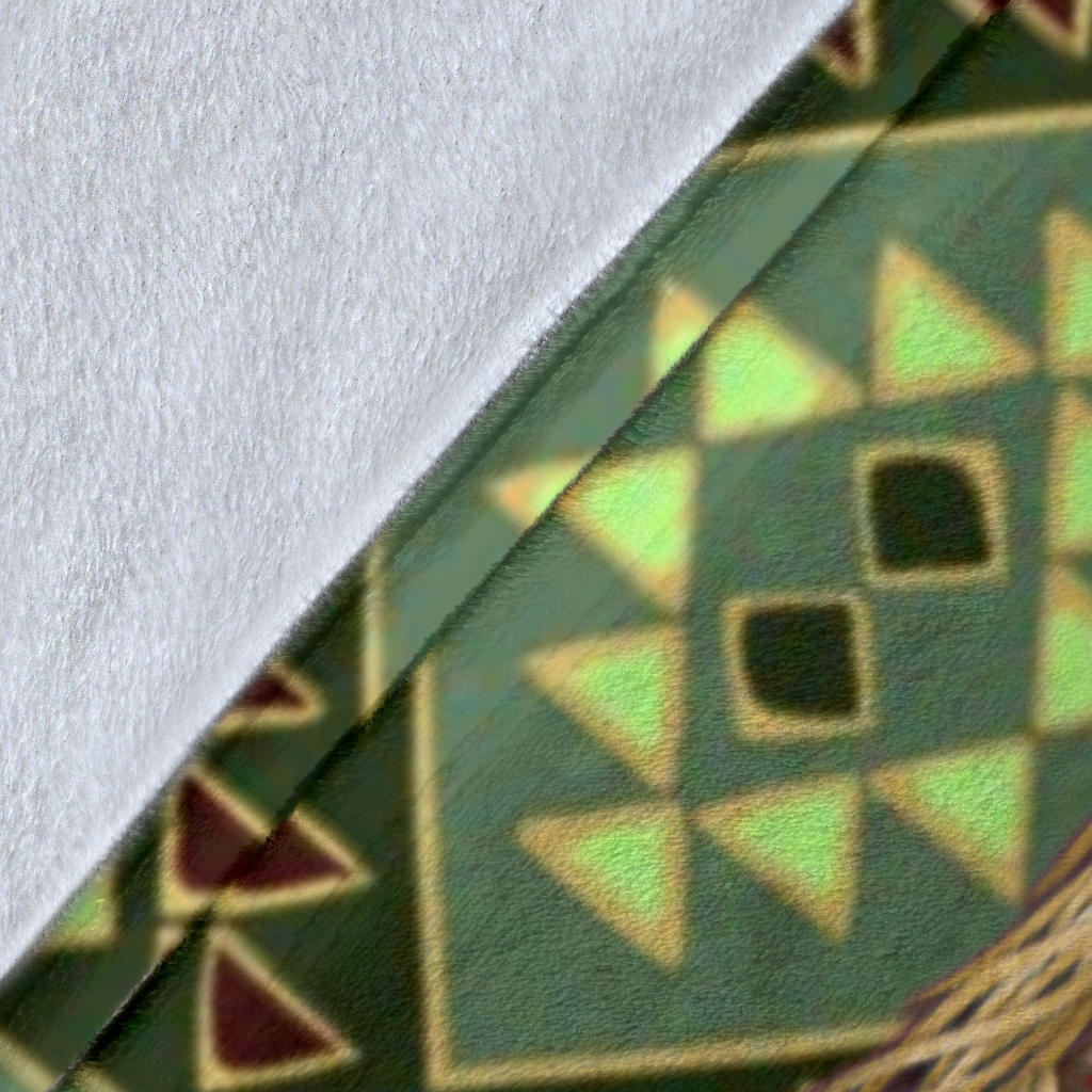 Close-up of green multicolor tribal blanket fabric with geometric triangle pattern