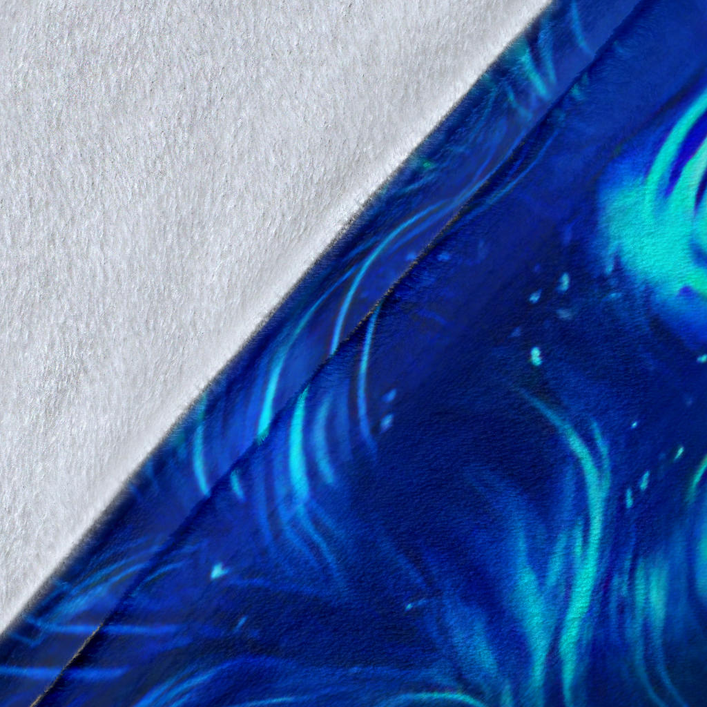 Close-up of Ice Fire Wolf blanket fabric with blue wolf artwork and flame accents