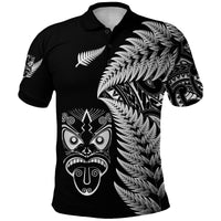 Black polo shirt with silver fern fronds and Māori tribal face graphic on front