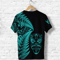 Black T-shirt with turquoise fern print and tribal face graphic on back