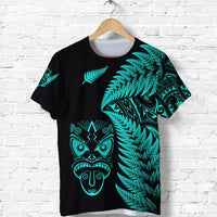 Black T-shirt with turquoise fern print and tribal face graphic on front