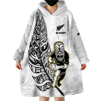 White wearable blanket hoodie worn like a poncho, featuring NZ Rugby warrior print