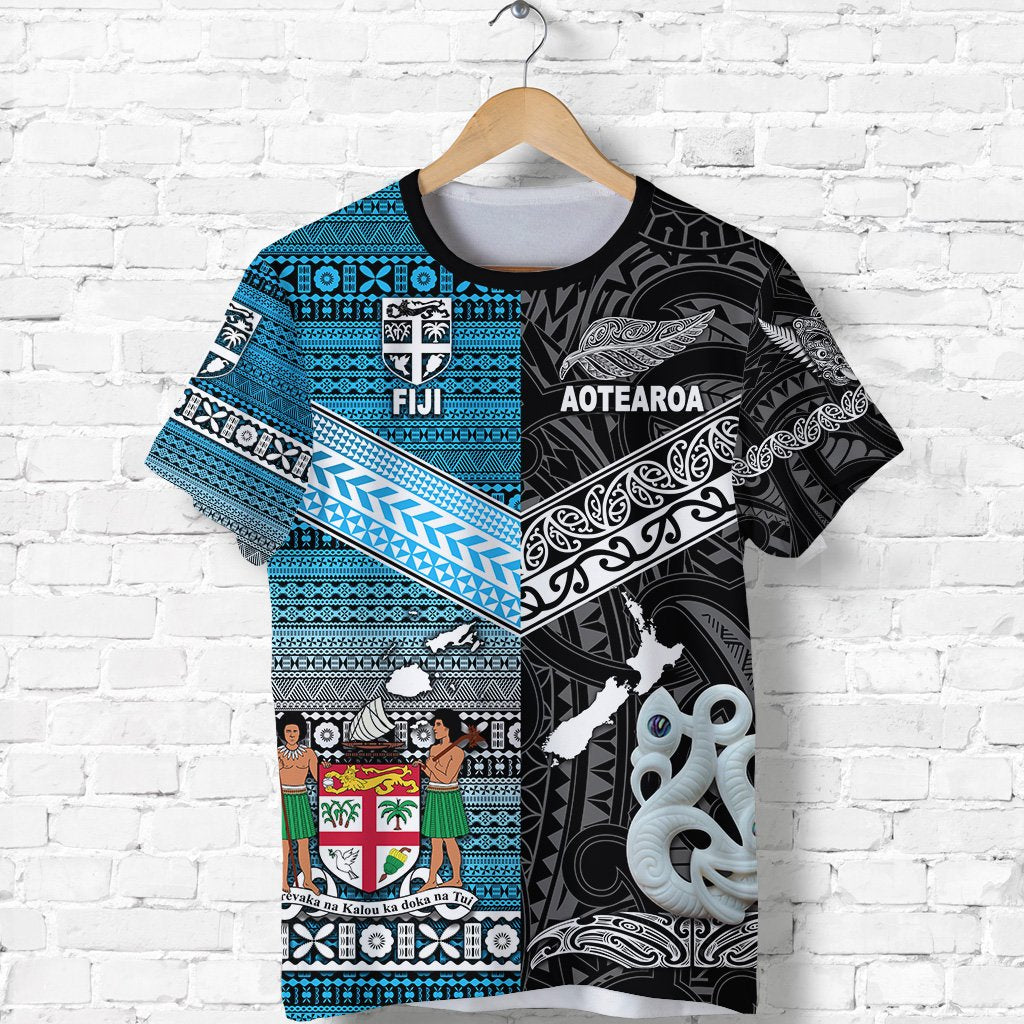 Black tee with blue geometric border; Fiji badge and white tiki-style figure