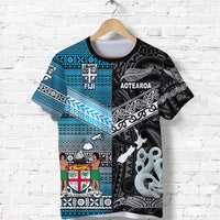 Black tee with blue geometric border; Fiji badge and white tiki-style figure