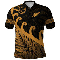 Black polo shirt with gold Maori pattern, fern and koru on front