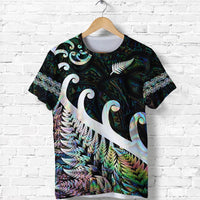 Green/black T-shirt with large fern and swirling koru graphic, iridescent shell details