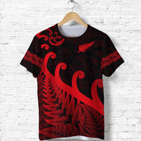 Dark rugby T-shirt with red Maori koru-style print on front