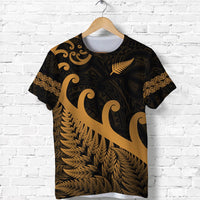 Black T-shirt with gold Maori koru and fern leaf diagonal graphic front