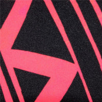 Printed pattern detail with pink and black curved shapes on dark textile