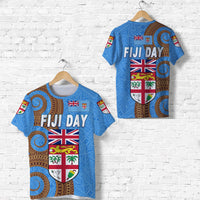 Blue “FIJI DAY” T-shirt with shield graphic and UK/Fiji flags