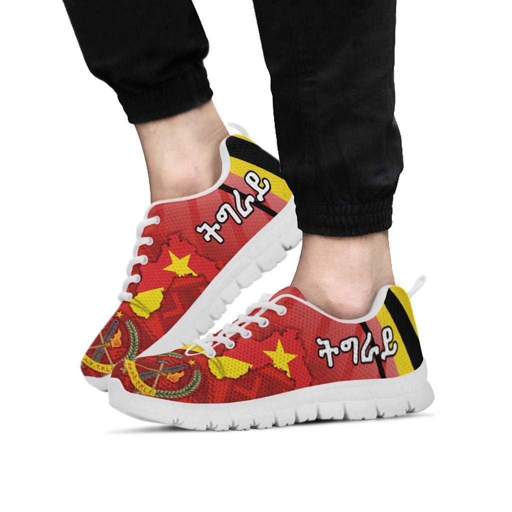 Tigray sneakers on feet, red/yellow design with stars, coat-of-arms, white sole