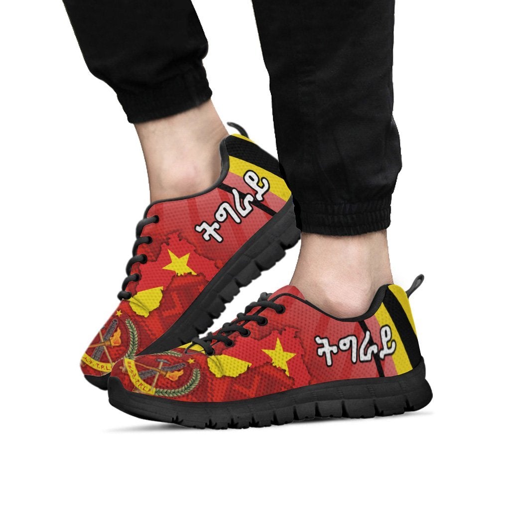 Tigray sneakers on feet, red/yellow star and coat-of-arms design, black sole