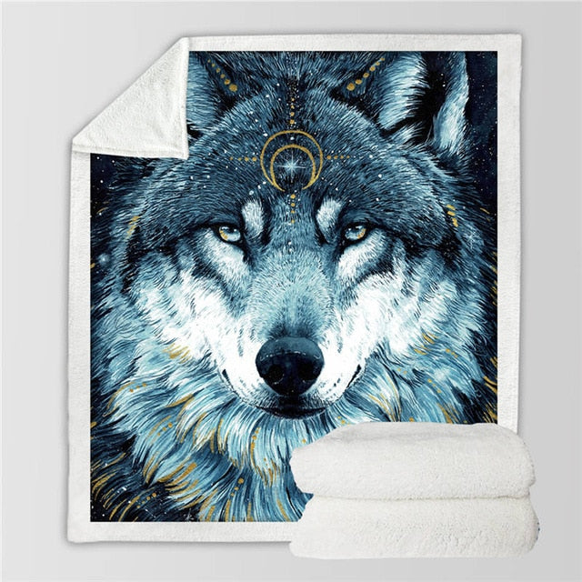 Folded blanket with close wolf face print in blue tones and gold circle accents