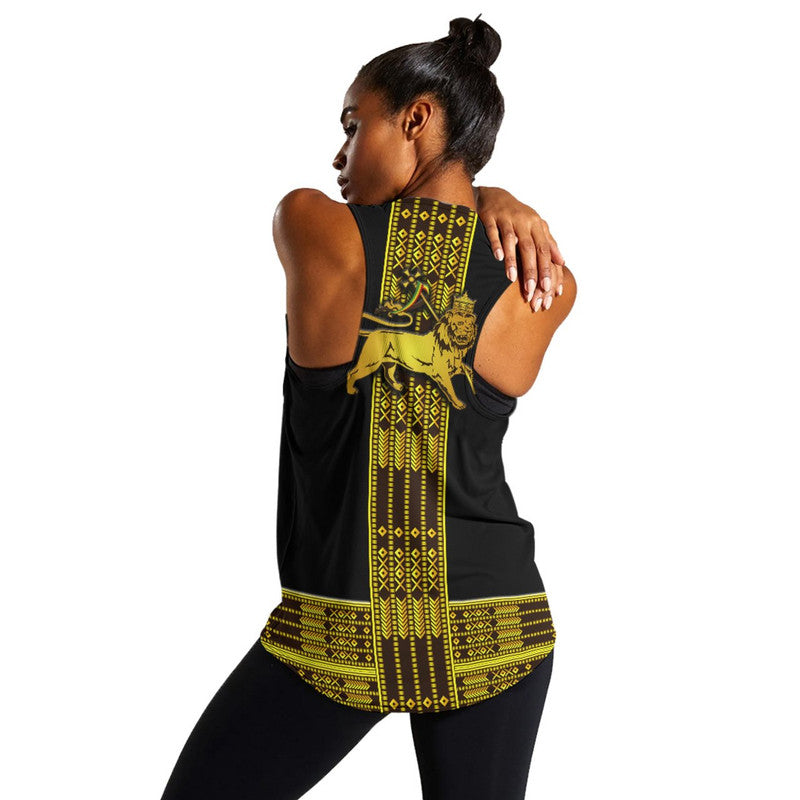 Back view: black racerback tank with yellow/gold Ethiopian-style pattern and lion print