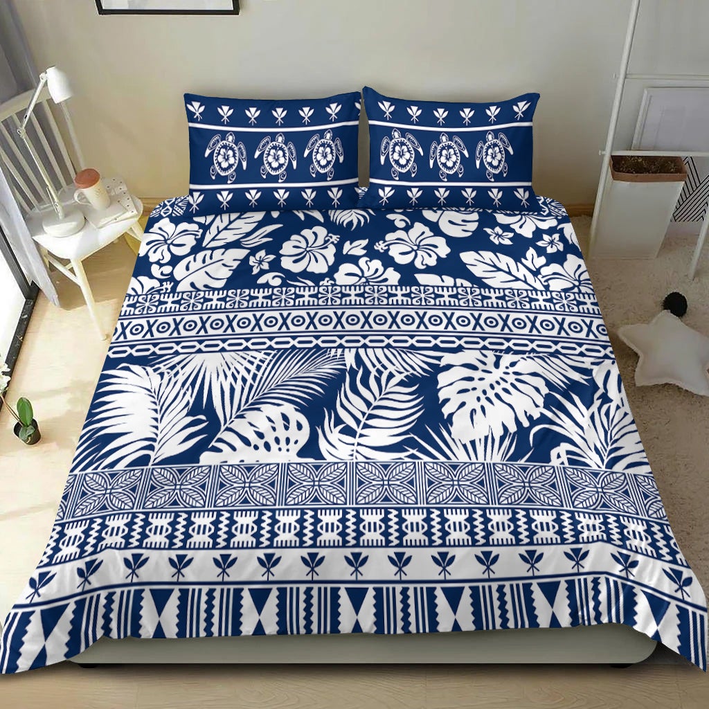 Navy and white bedding set with tropical leaves, floral motifs, and patterned borders